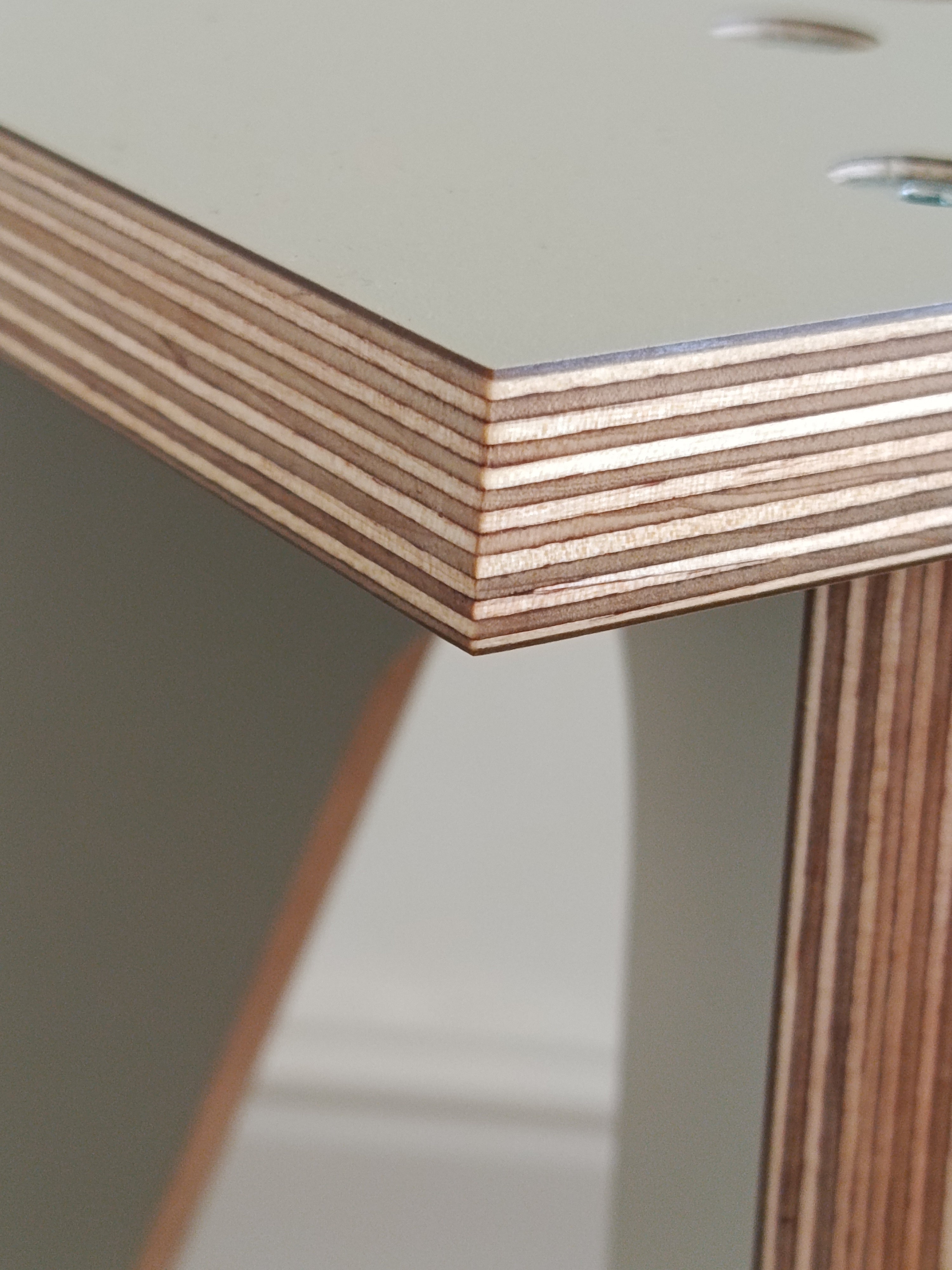 Close up of the sanded and oiled birch plywood edge of the model 01 tripod speaker stand.